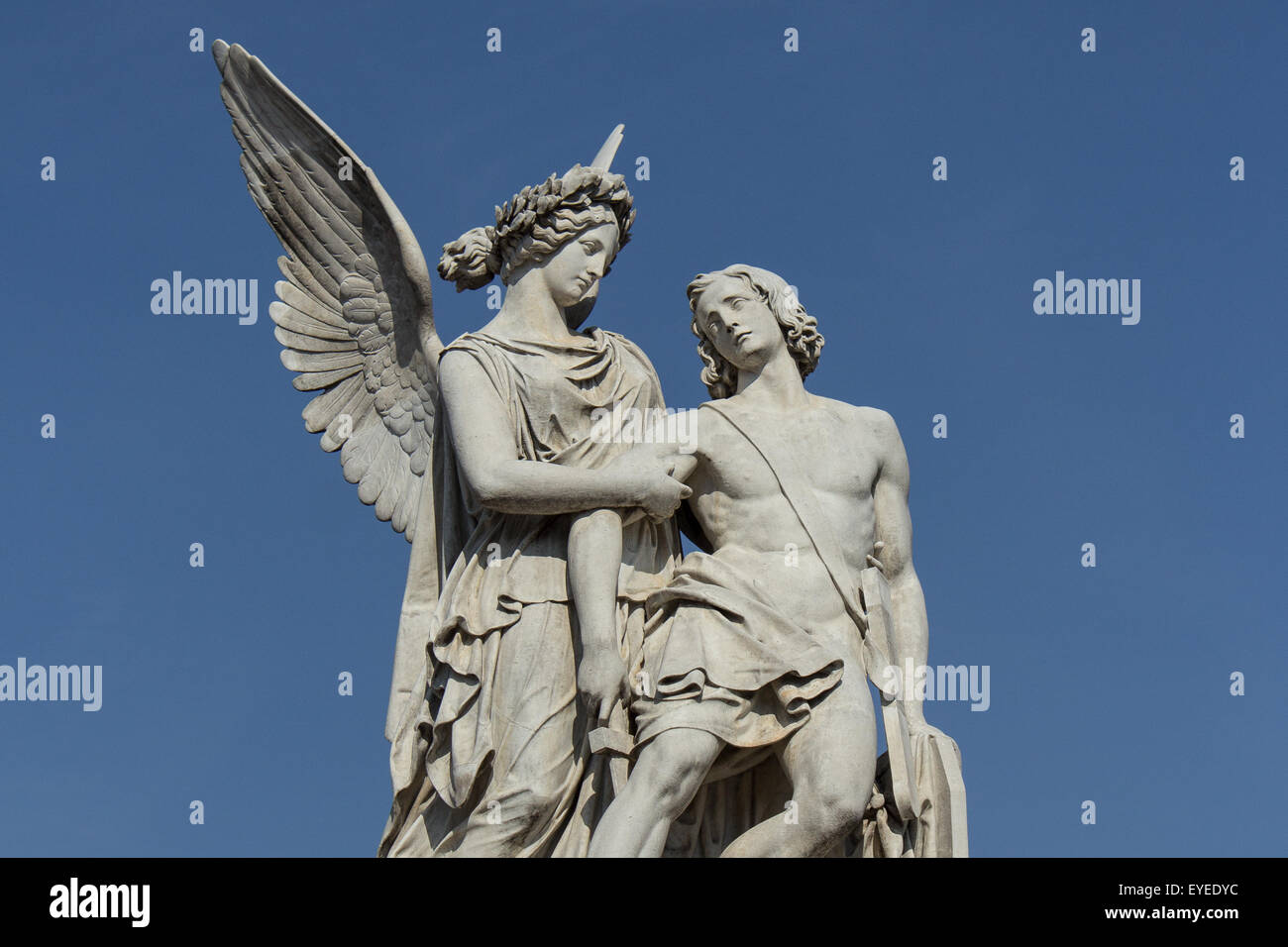 female angel statue helping wounded male Stock Photo