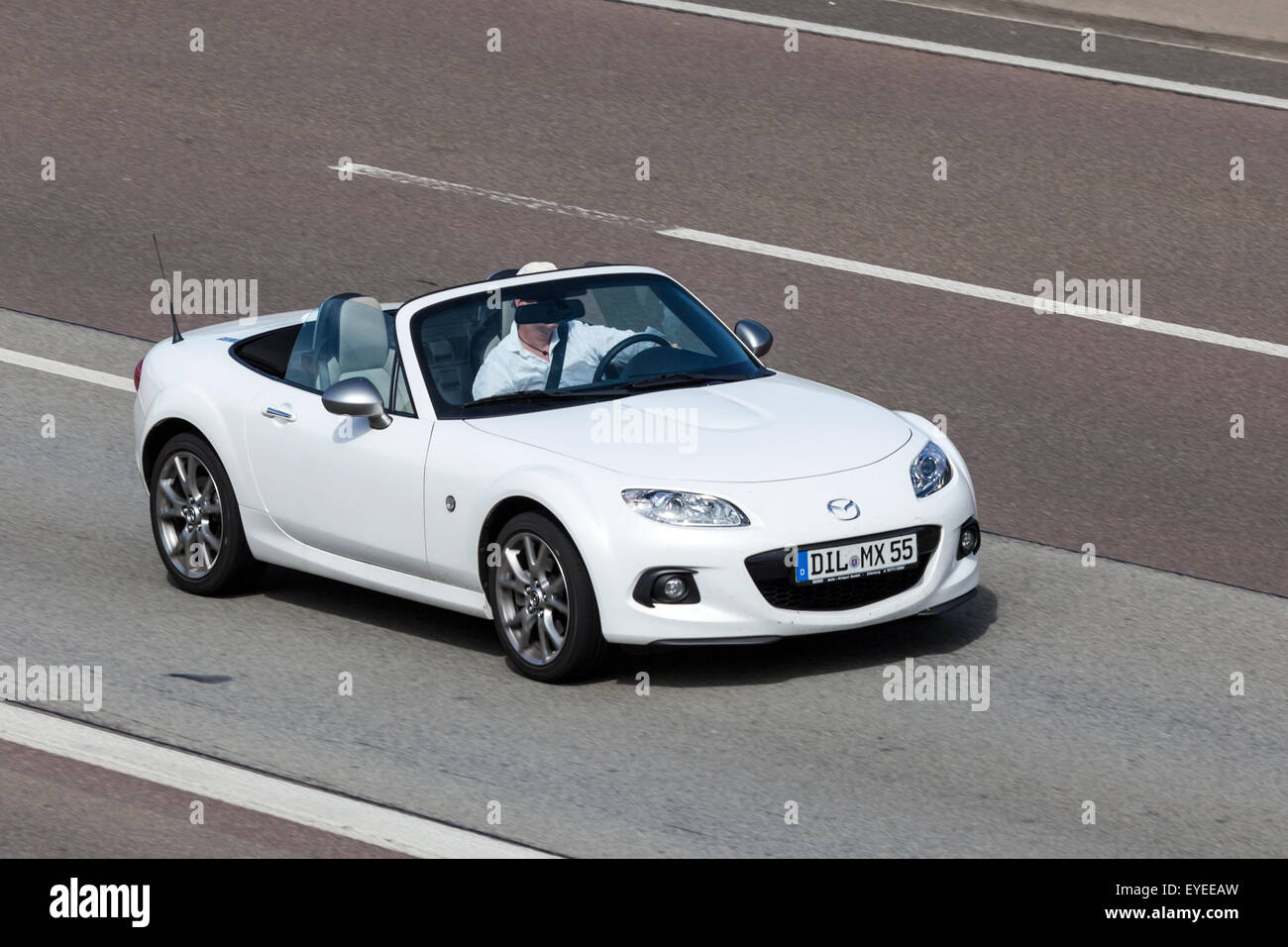 White Mazda MX-5 Roadster moving fast on the highway Stock Photo