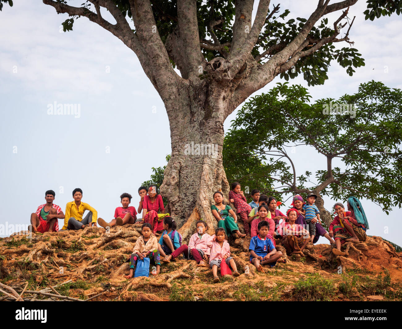 Villagers gathered under large tree in Kumpur, Dhadhing, Nepal Stock Photo