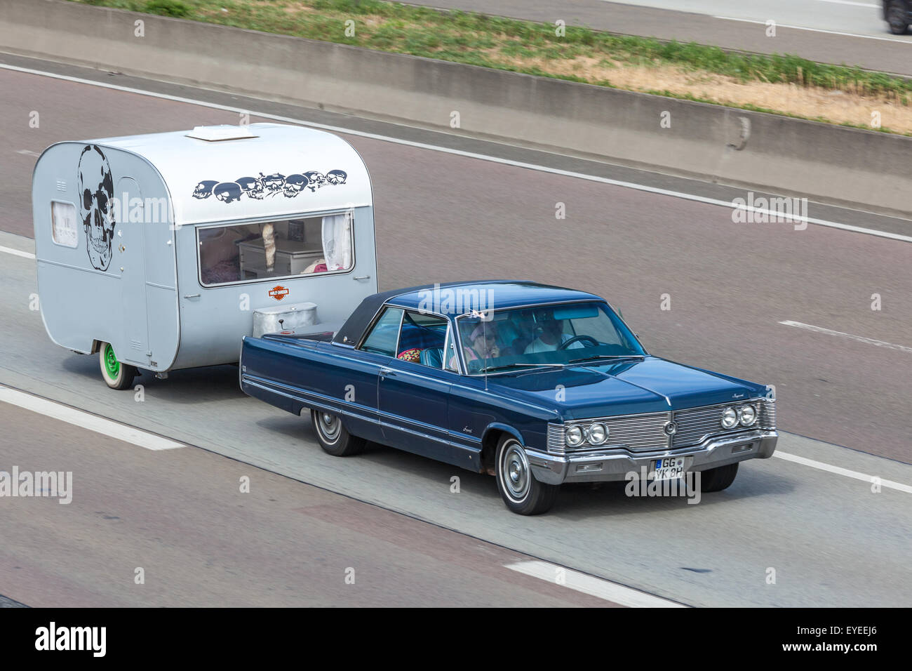 Classic American coupe with an old caravan Stock Photo