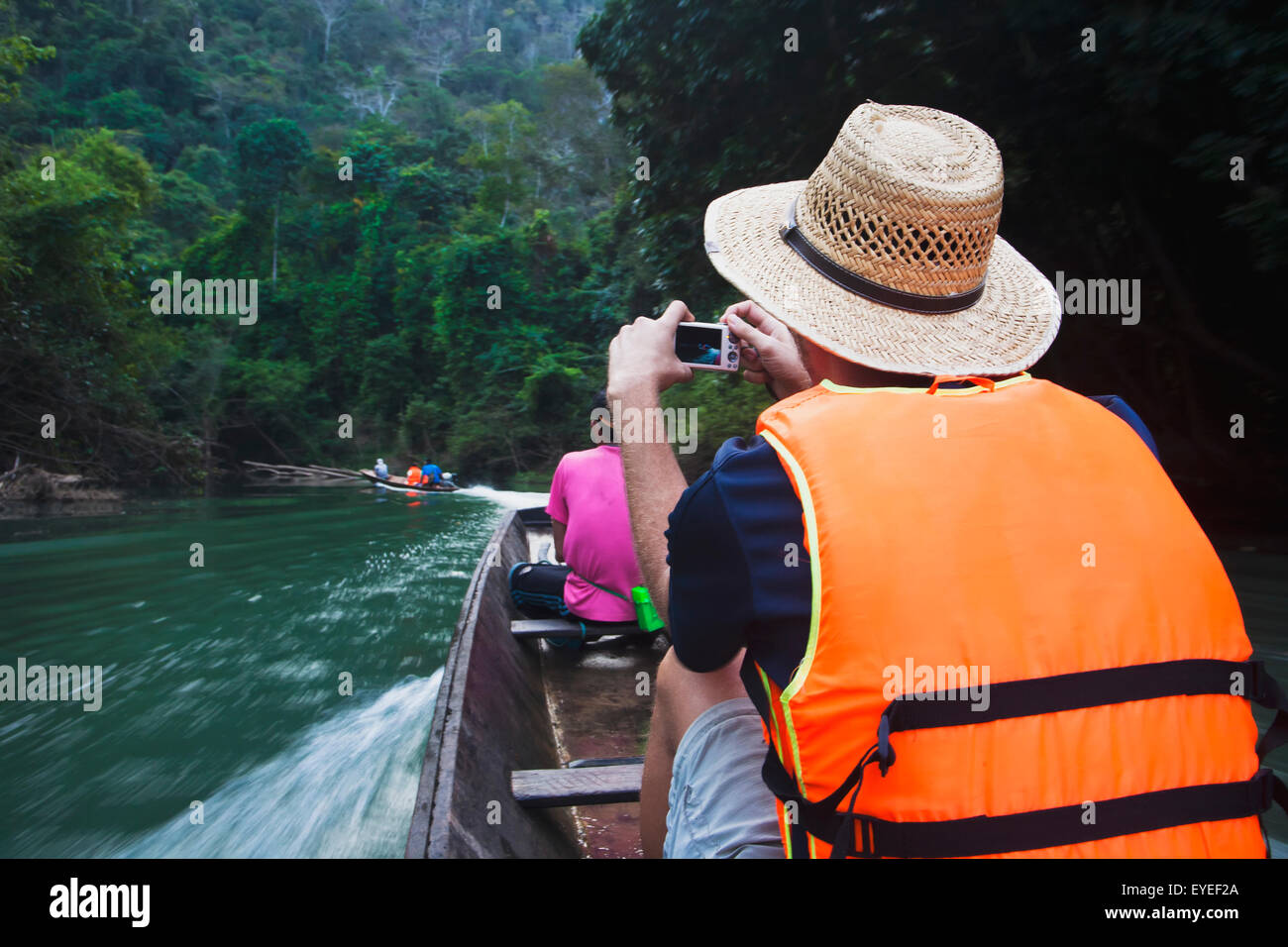 Tourists taking a longboat tour of stunning caves, 7 kilometre caves; Kong Lor, Laos Stock Photo