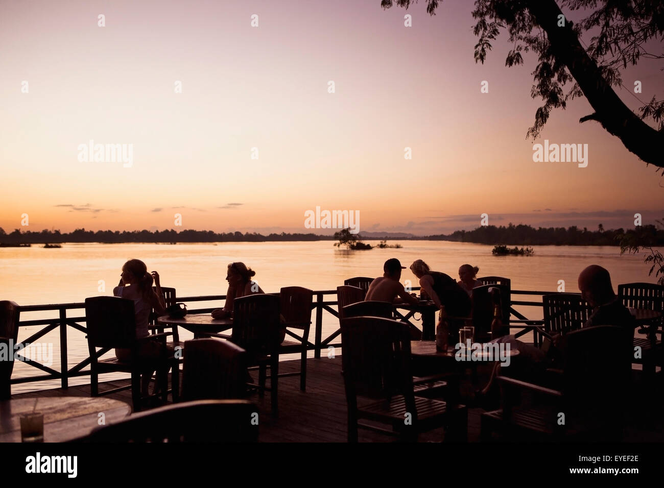 Sunset viewed from a restaurant's outdoor patio on the water; Laos Stock Photo