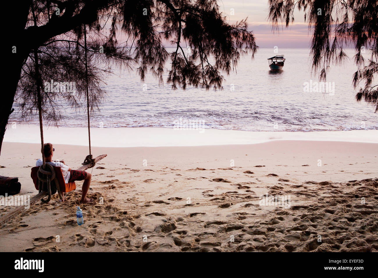 Relaxing on a beach swing; Bamboo Island, Cambodia Stock Photo