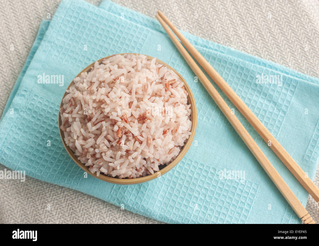 Rice berry, Brown rice and chopsticks in bowl Stock Photo