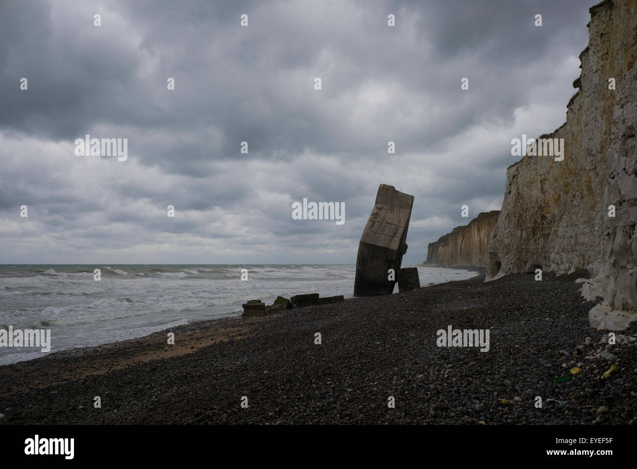 WW2 blockhouse on beach, stormy sky, St Marguerite-sur-Mer, Normandy, France Stock Photo