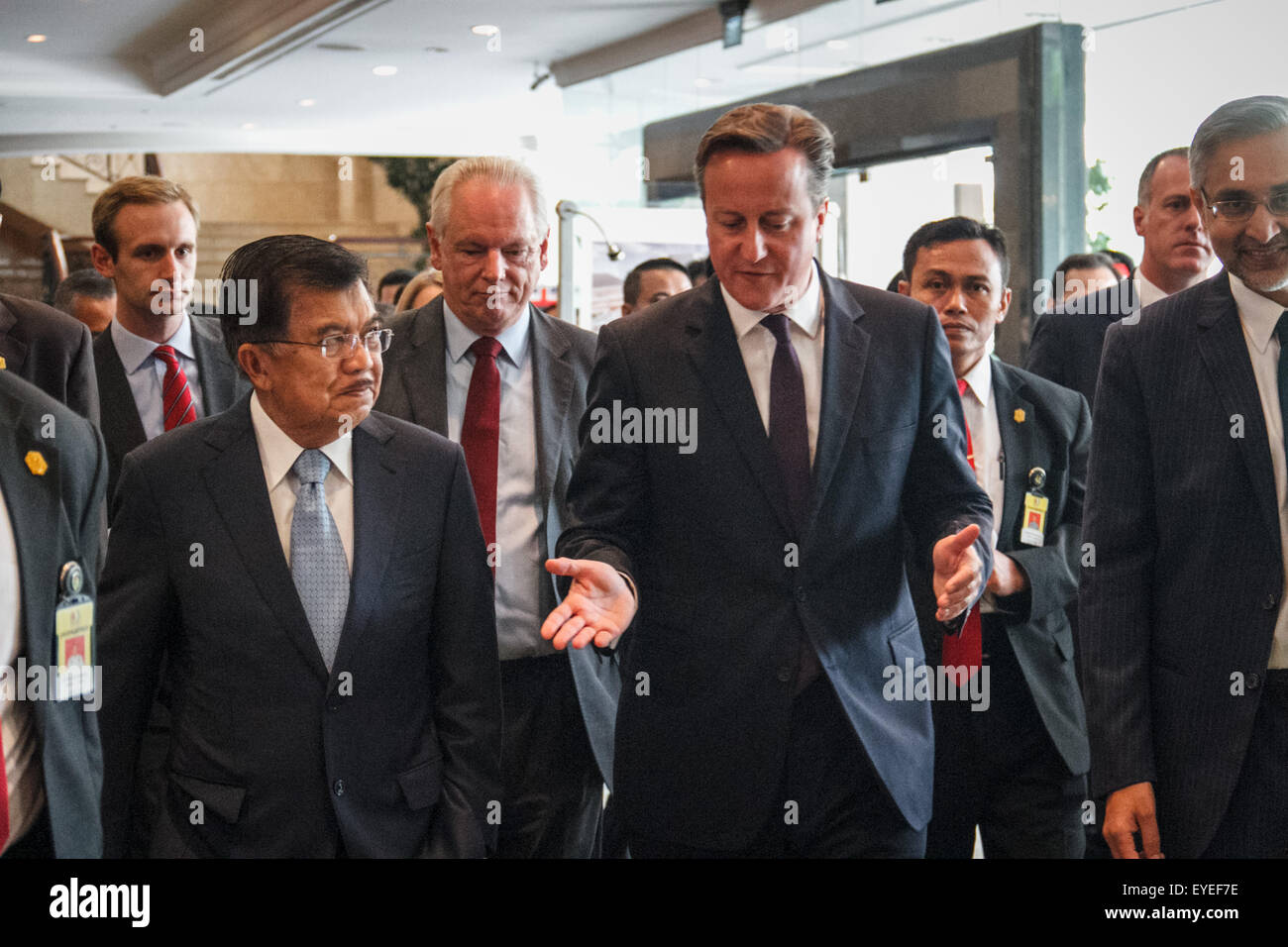 Jakarta, Indonesia. 28th July, 2015. Indonesian Vice President Jusuf Kalla (C left) and British Prime Minister David Cameron (C right) leave the venue after the opening of the UK-Indonesia Business Forum in Jakarta. British Prime Minister David Cameron visits Indonesia, looking to seal 1.2 billion in trade deals and cooperation in the fight against the Islamic State group extremism. Credit:  Garry Andrew Lotulung/Pacific Press/Alamy Live News Stock Photo