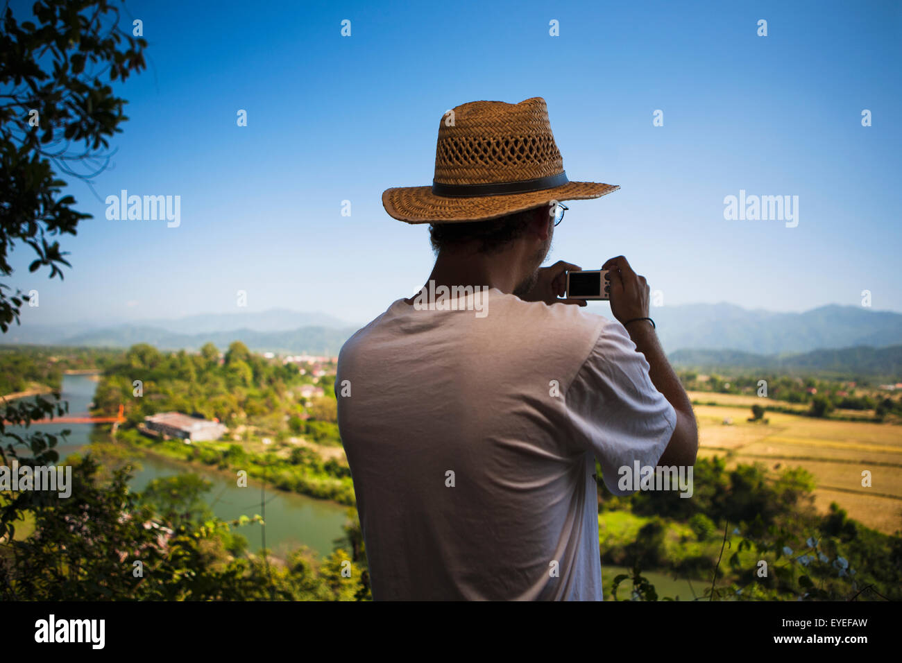A man views the countryside; Vang Vieng, Laos Stock Photo