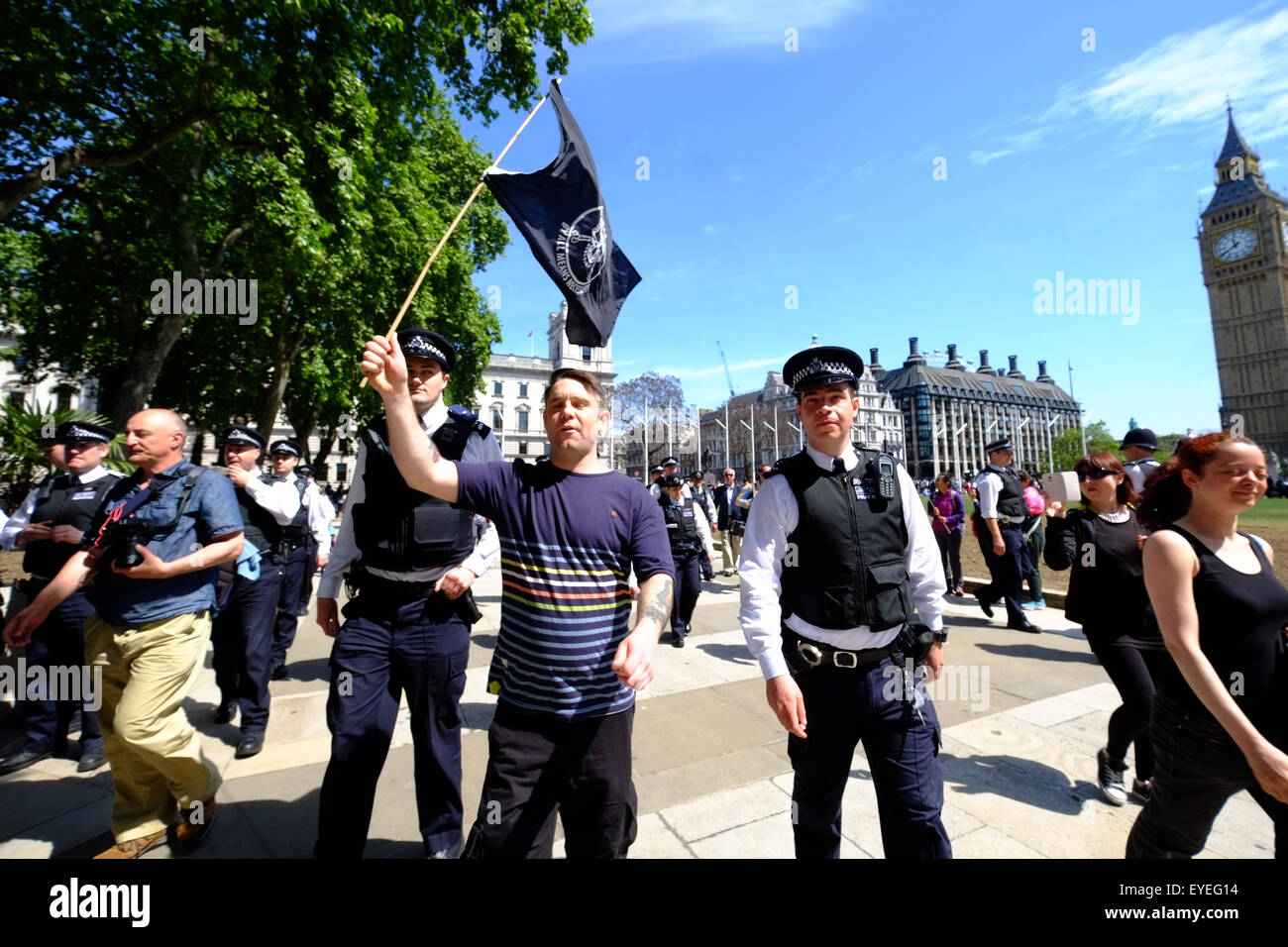 Members of Class War are escorted by Police from Parliament Sq during the State Opening of Parliament  Featuring: Atmosphere Where: London, United Kingdom When: 27 May 2015 C Stock Photo
