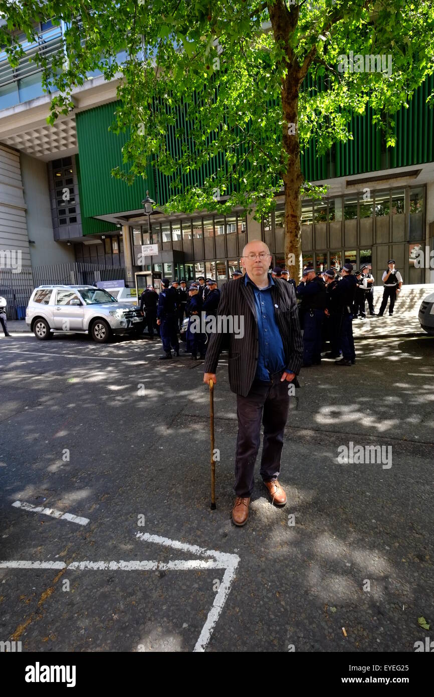 Members of Class War are escorted by Police from Parliament Sq during the State Opening of Parliament  Featuring: Atmosphere, Ian Bone leader of Class war Where: London, United Kingdom When: 27 May 2015 C Stock Photo