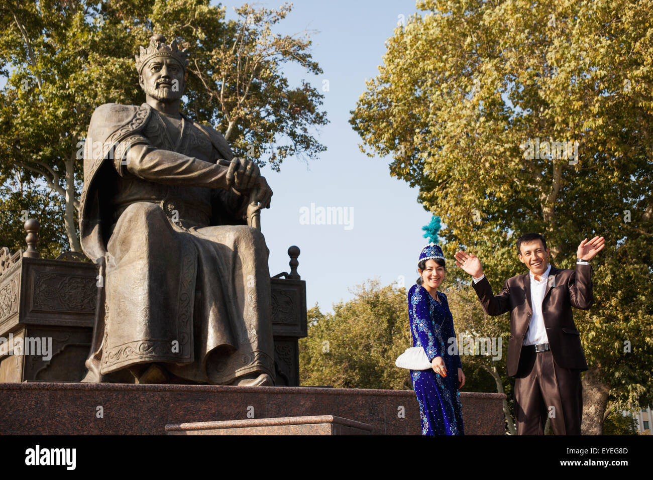 Wedding couple at Amir Timur statue; Samarkand, Uzbekistan Stock Photo