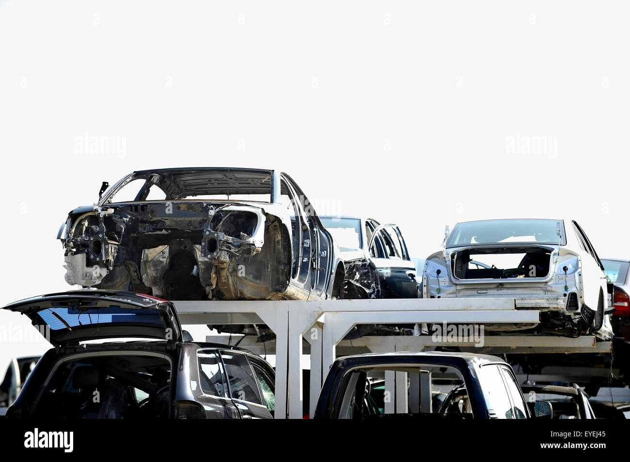 Wrecked vehicles are seen in a car junkyard Stock Photo