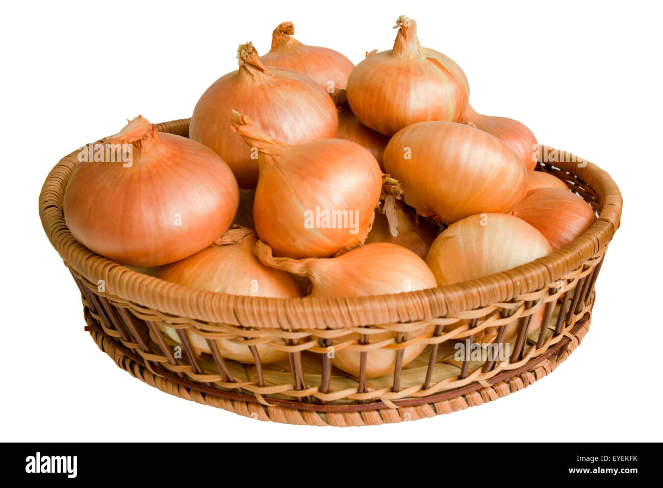Still life with dried onions, laid out flat in a wicker cradle on white background. Stock Photo