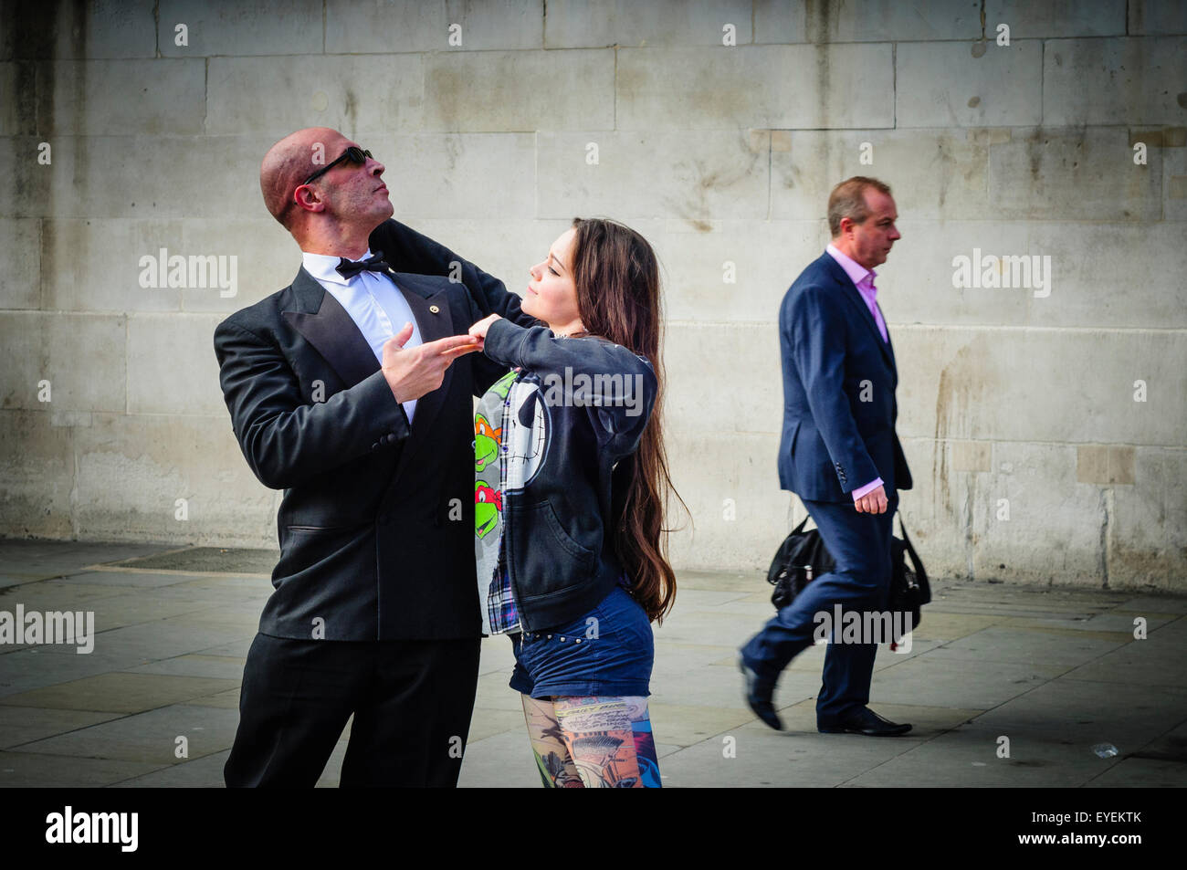 Street entertainer posing with a member of public in London, UK Stock Photo