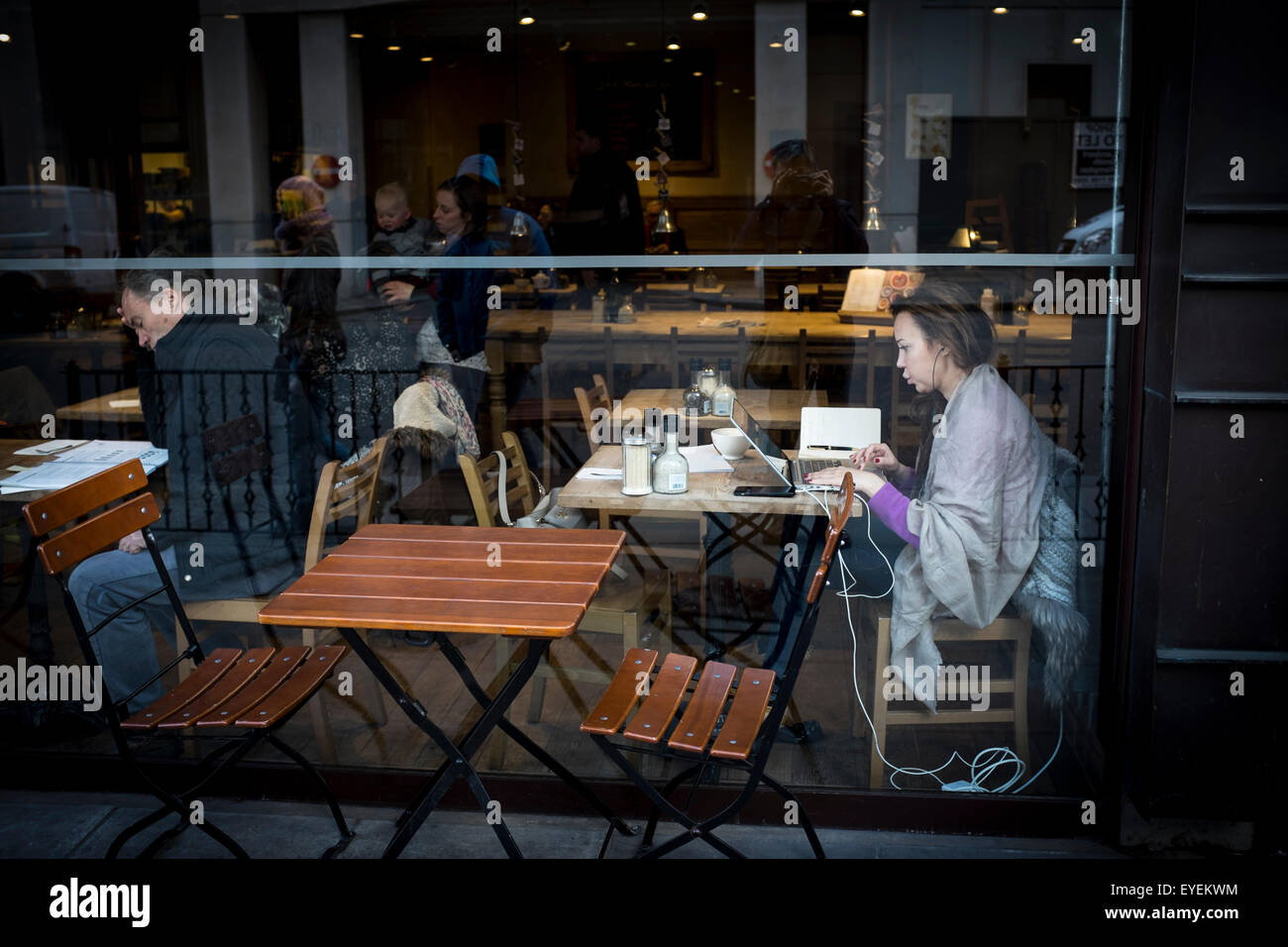 Young female using computer in a cafe, London, UK Stock Photo