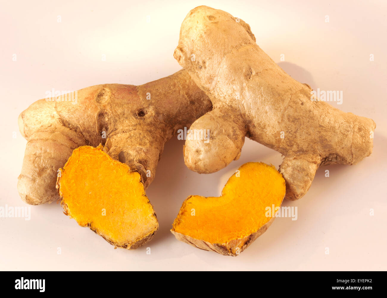 WHOLE TUMERIC ROOT AND SLICES Stock Photo
