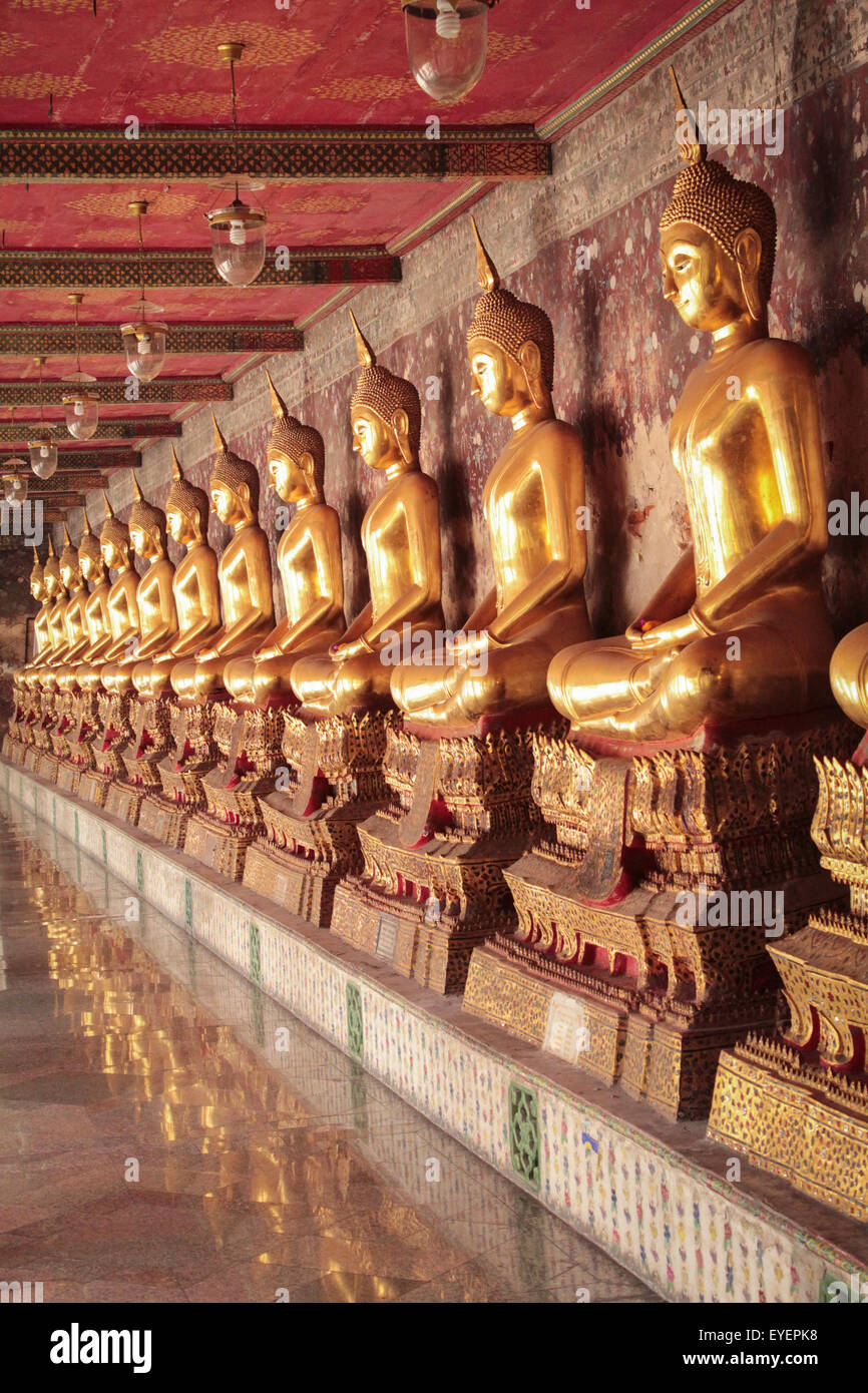 golden buddha statues in a row , buddhist temple bangkok Thailand Stock ...