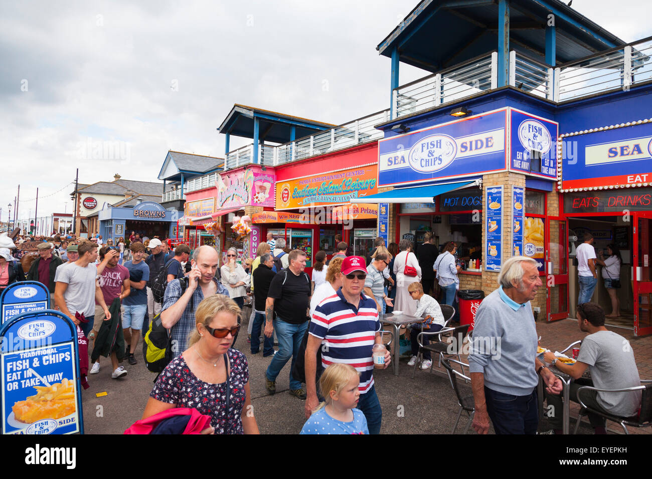 Crowds around a fast food outlet by the seaside Stock Photo
