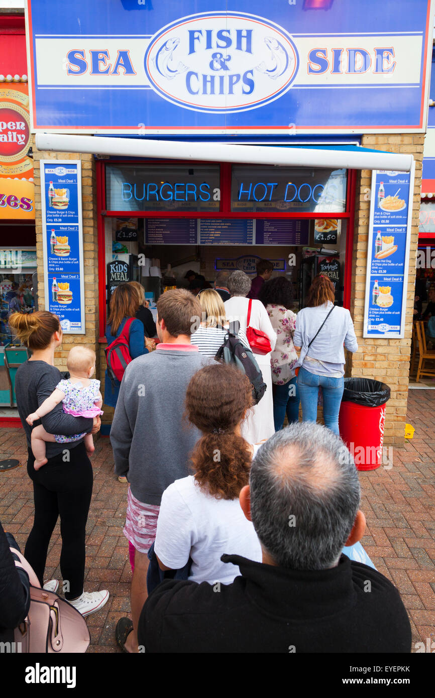 People queue for fish and chips at the seaside Stock Photo