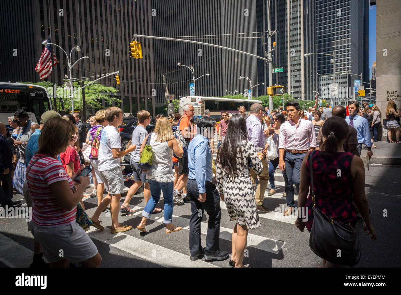 Pedestrians cross a busy Fifth Avenue intersection in New York on Thursday, July 23, 2015. (© Richard B. Levine) Stock Photo