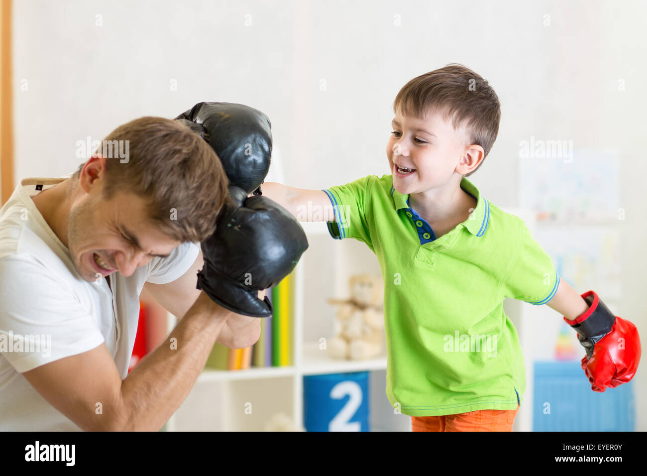 child and dad play boxing Stock Photo