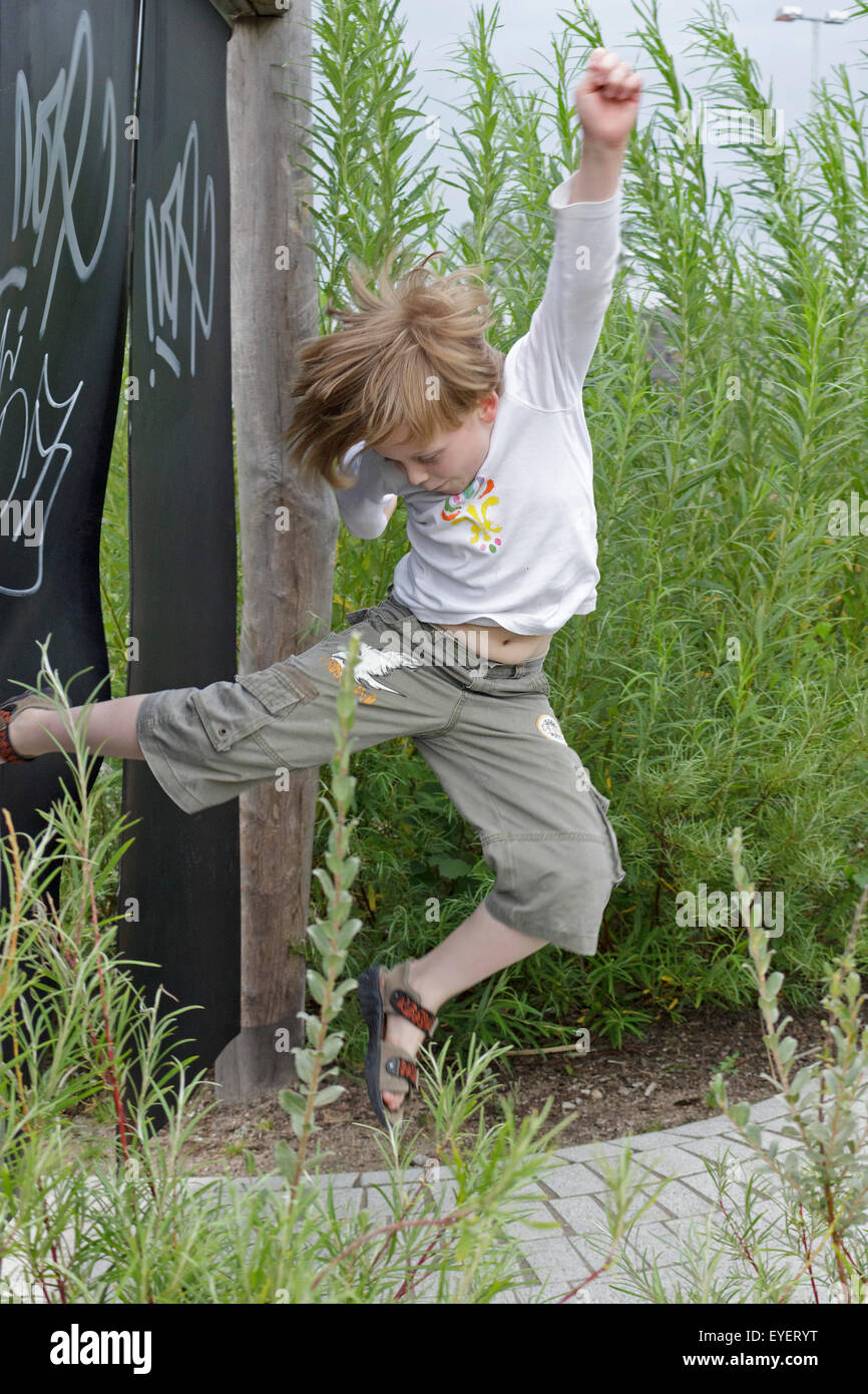 young boy doing a karate jump Stock Photo