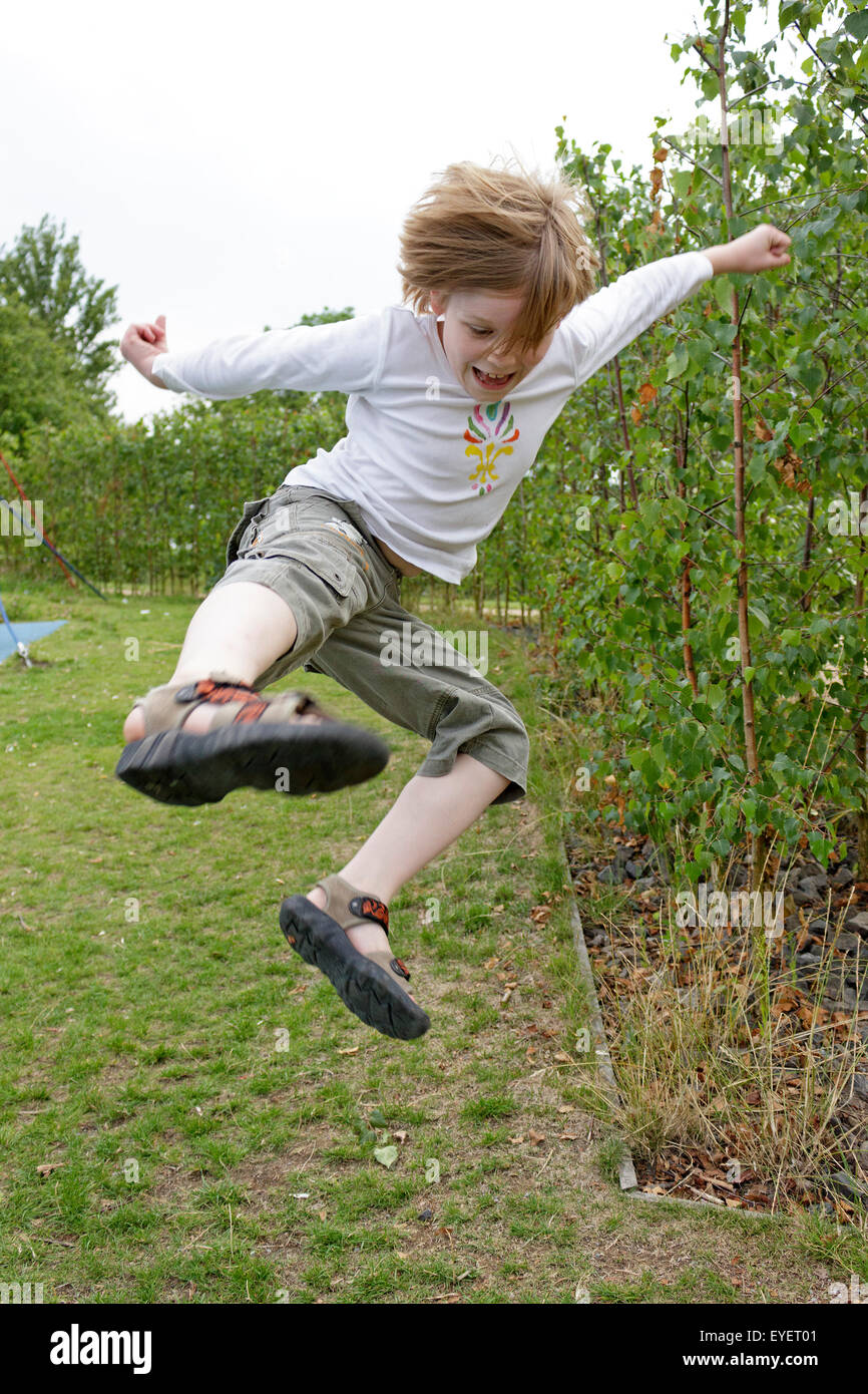 young boy doing a karate jump Stock Photo