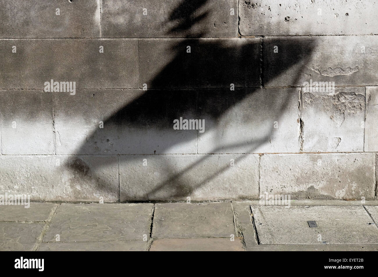 A shadow of a lamppost on a wall Stock Photo