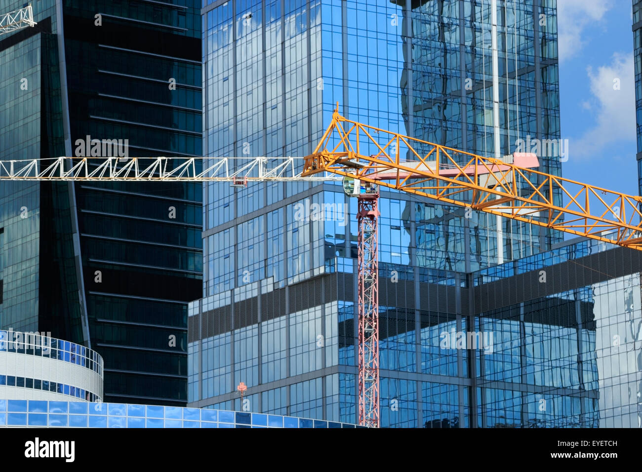 Contemporary architecture and construction site with cranes. Stock Photo