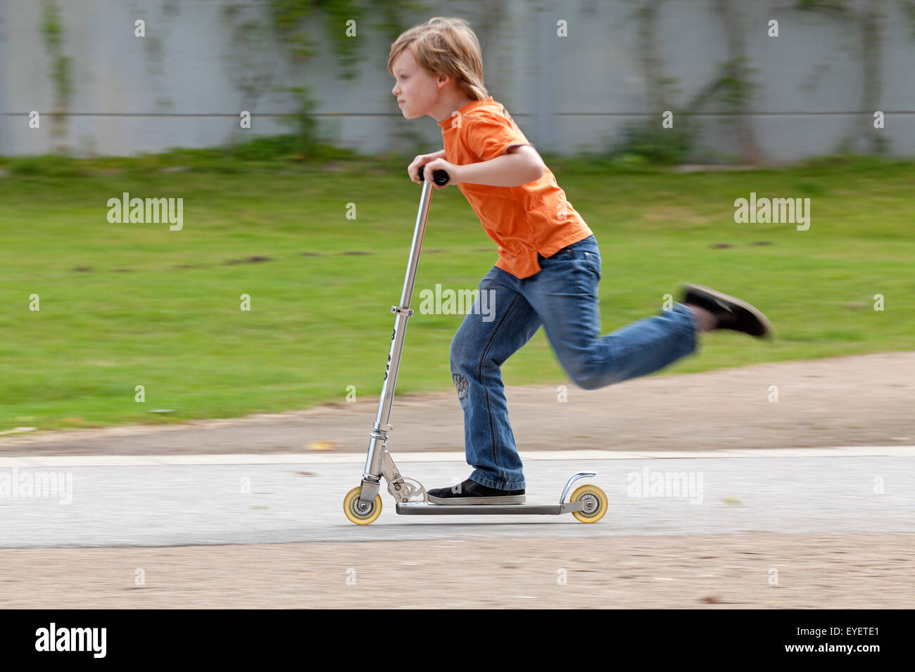 young boy on a scooter Stock Photo