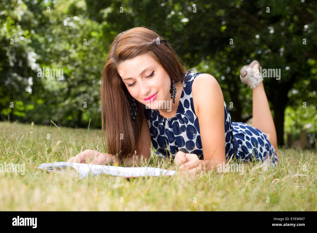 young woman reading a book in the park Stock Photo