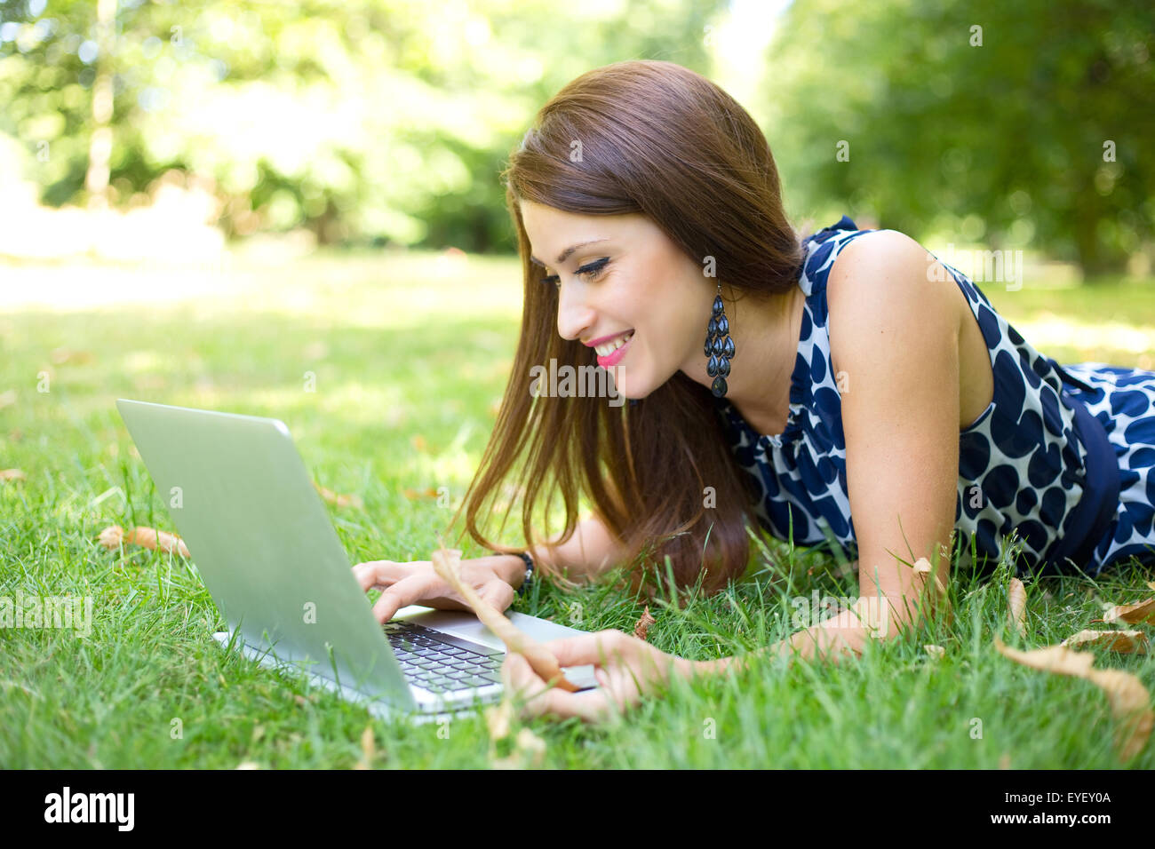 young woman using her laptop in the park Stock Photo - Alamy