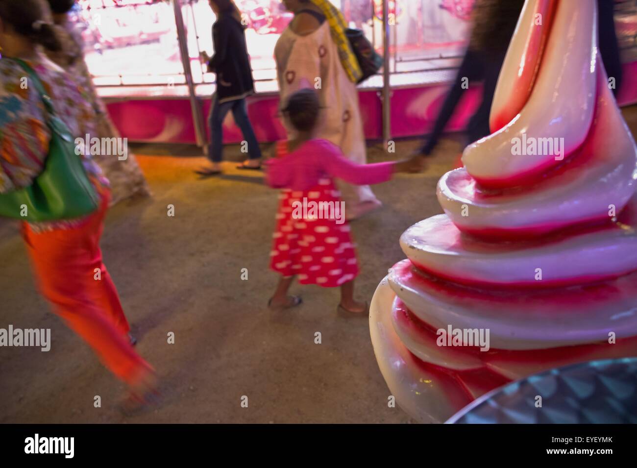 Scene of Saturday evening in the fun fair In a place steeped in history of France, every summer the Garden of the Tuileries welcomes about sixty fairground attractions for the enjoyment and the pleasure of the children and the parents. For several years t Stock Photo