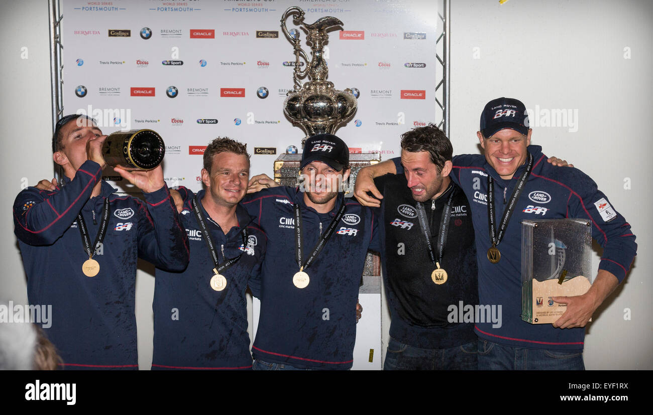 Mcc0063997 Covered in champagne, Sir Ben Ainslie (fourth from left) poses with members of his sailing team after winning the Ame Stock Photo