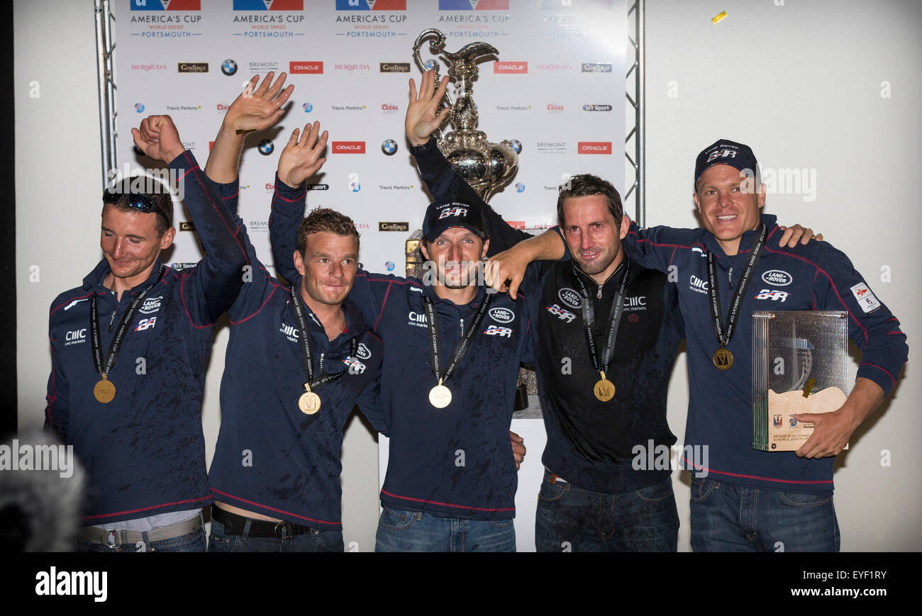 Covered in champagne, Sir Ben Ainslie (fourth from left) poses with members of his sailing team after winning LVACWS Portsmouth Stock Photo
