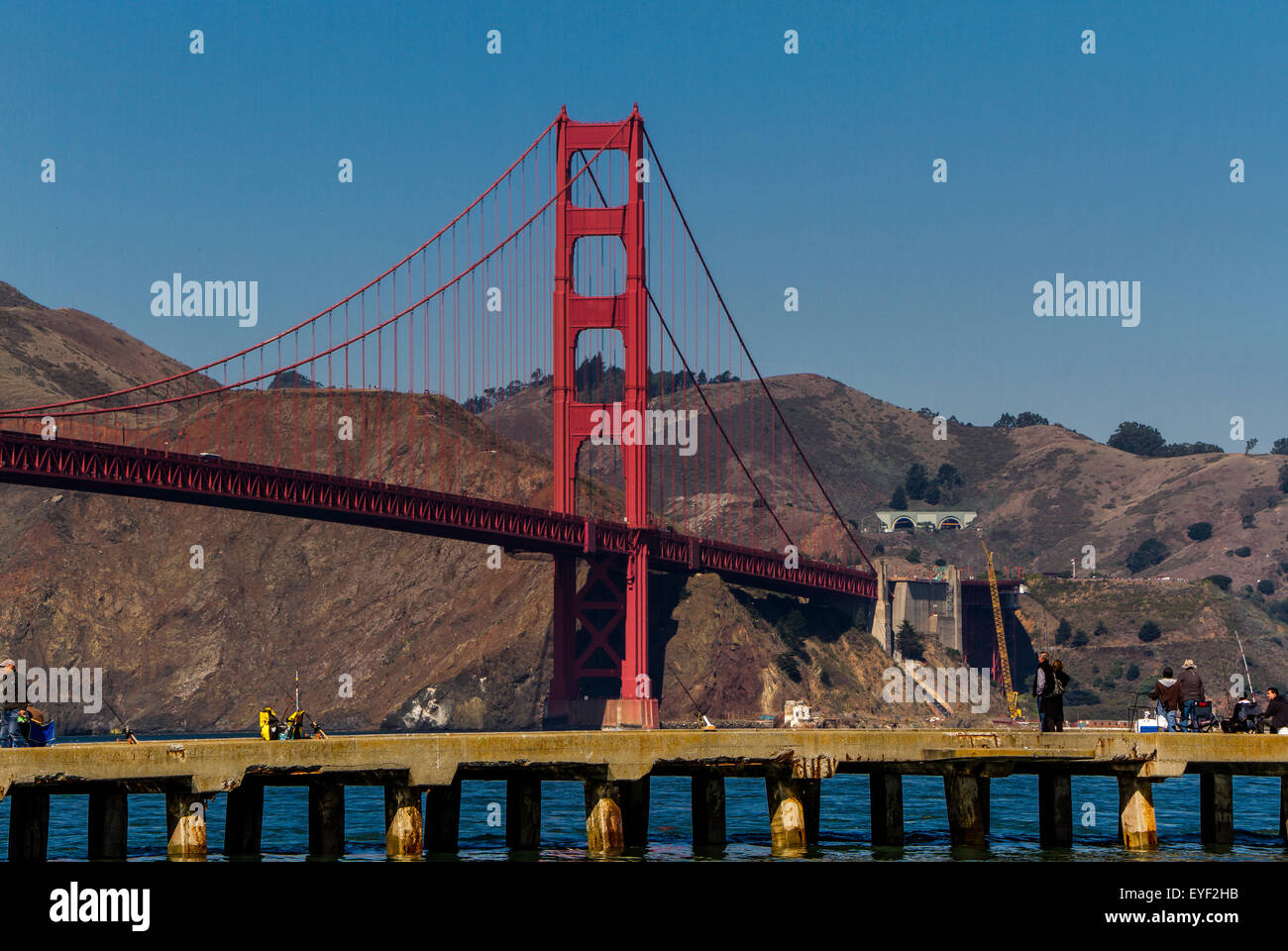 People fishing from a wooden jetty near The Golden Gate Bridge, San