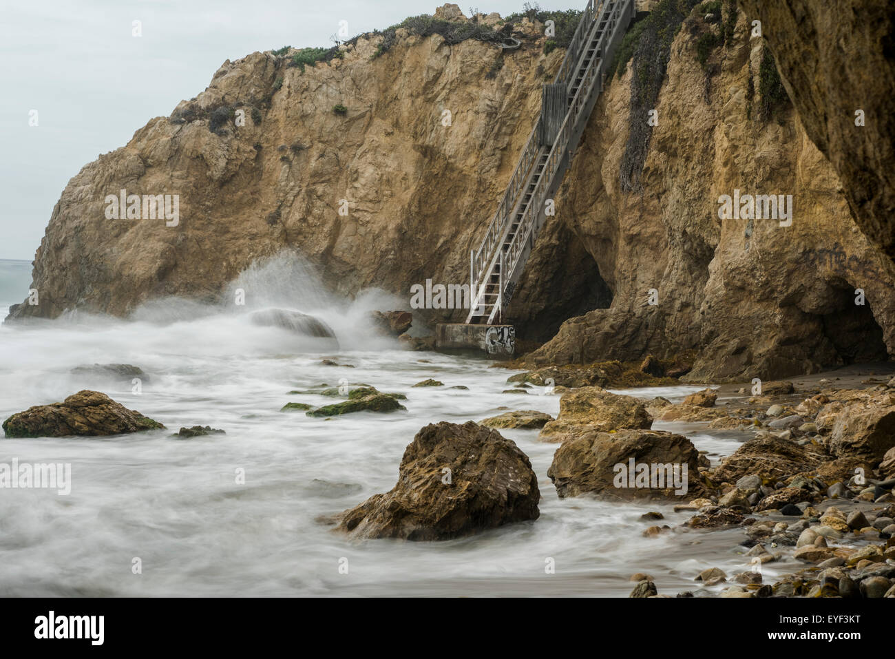 Stairway to a raging sea. Matador Beach, Malibu, CA Stock Photo