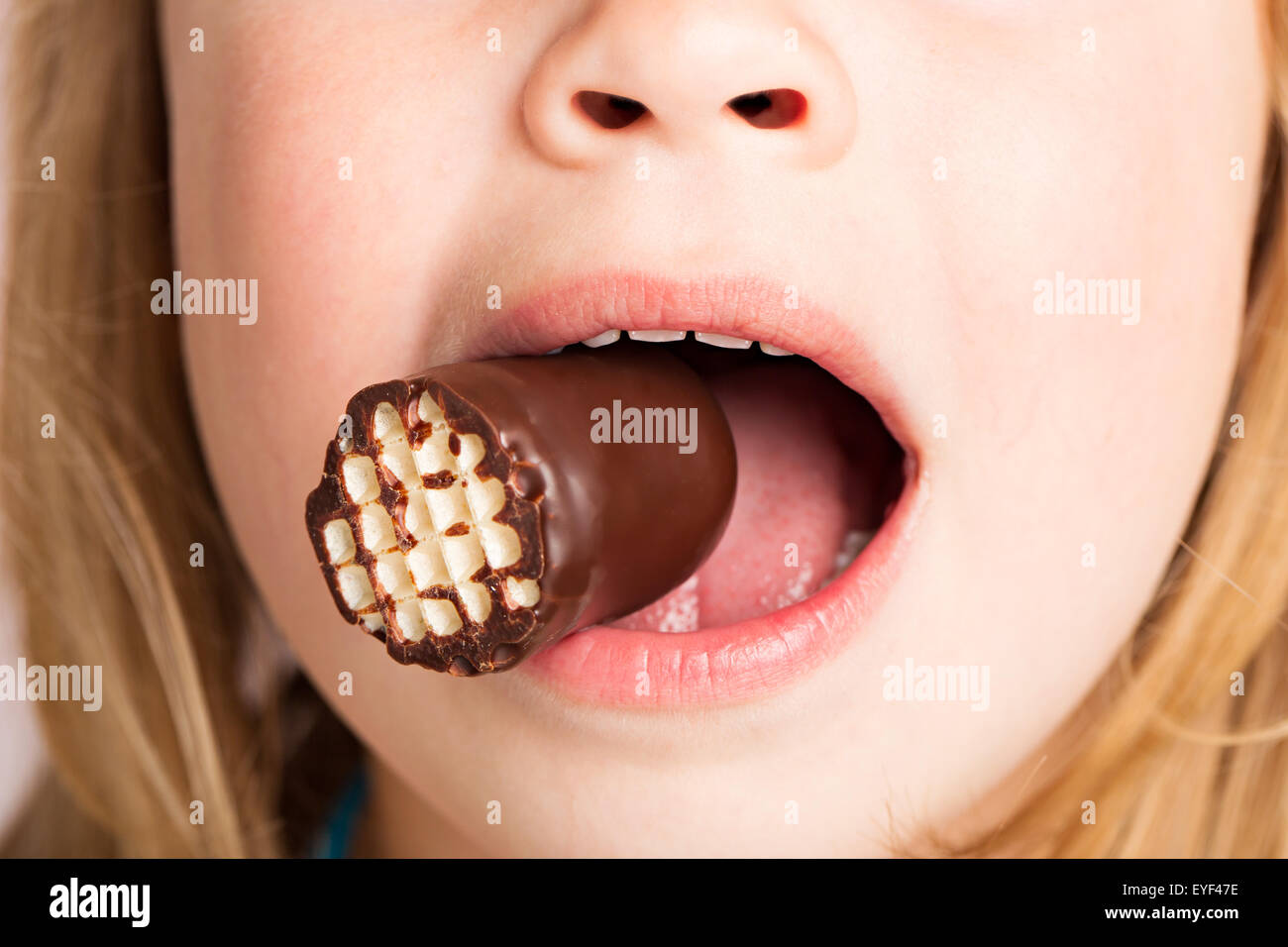 Chocolate marshmallow in mouth Stock Photo