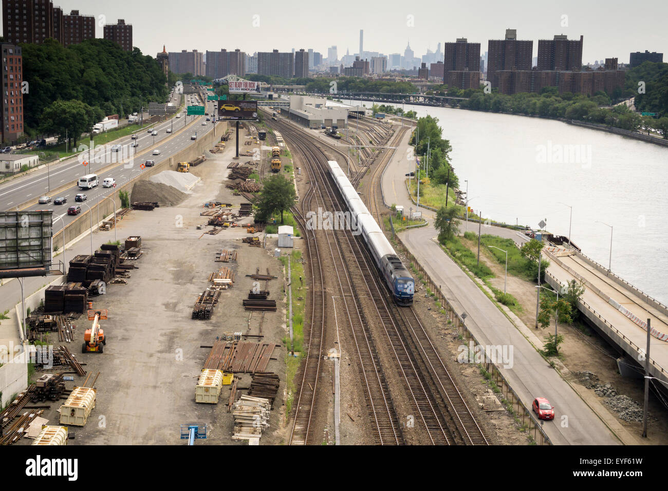 A Metro-North commuter train travels next to the Harlem River in the Bronx in New York on Saturday, July 25, 2015. The Major Deegan Expressway parallels the railroad at this location. (© Richard B. Levine) Stock Photo