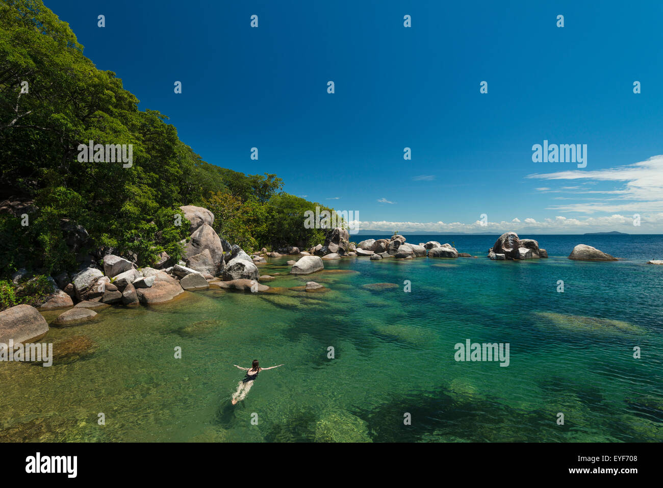 Woman swimming in clear waters surrounding Mumbo Island, Lake Malawi; Malawi Stock Photo