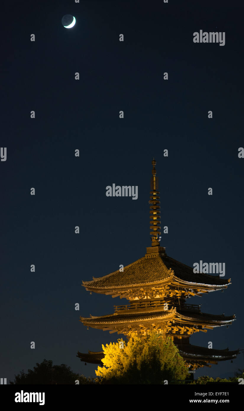 Night view of a Japanese pagoda with moon crescent; Kyoto, Japan Stock Photo