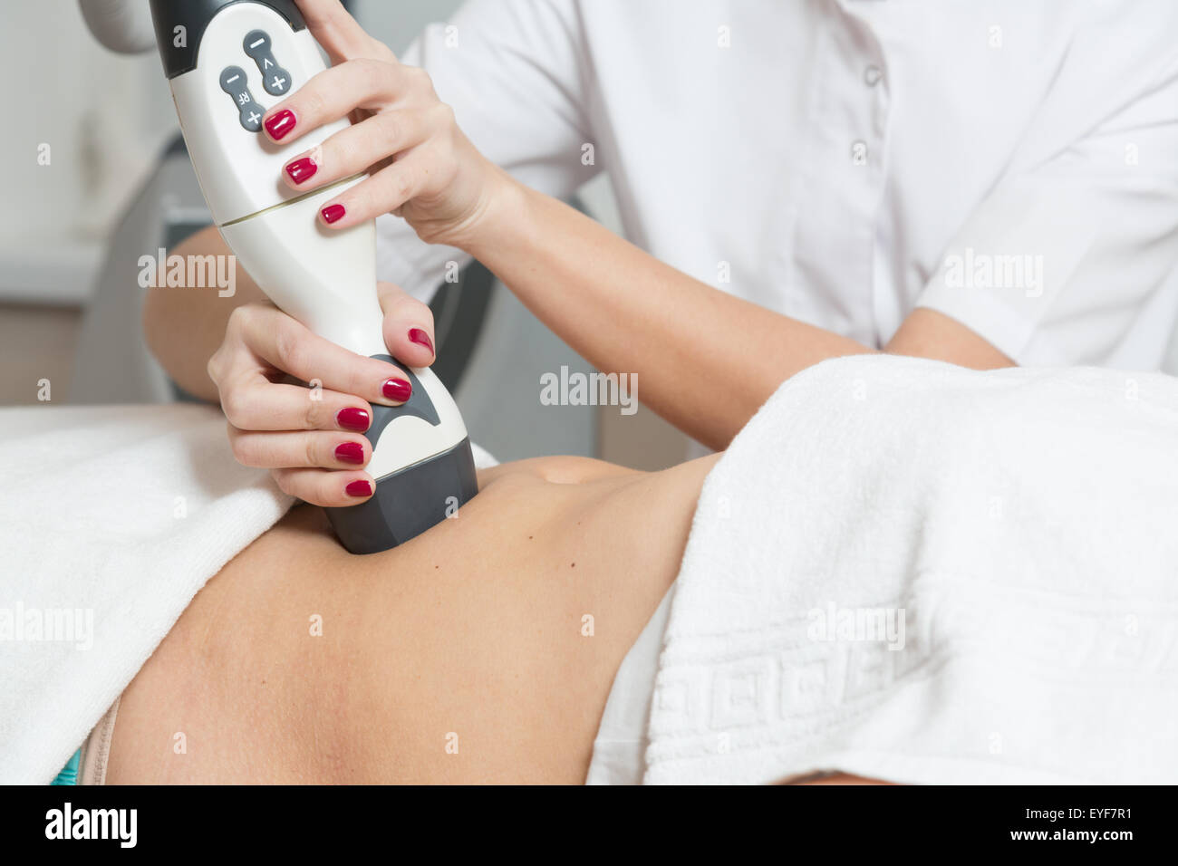 Cosmetician  making procedure of lymphatic drainage with a professional equipment Stock Photo