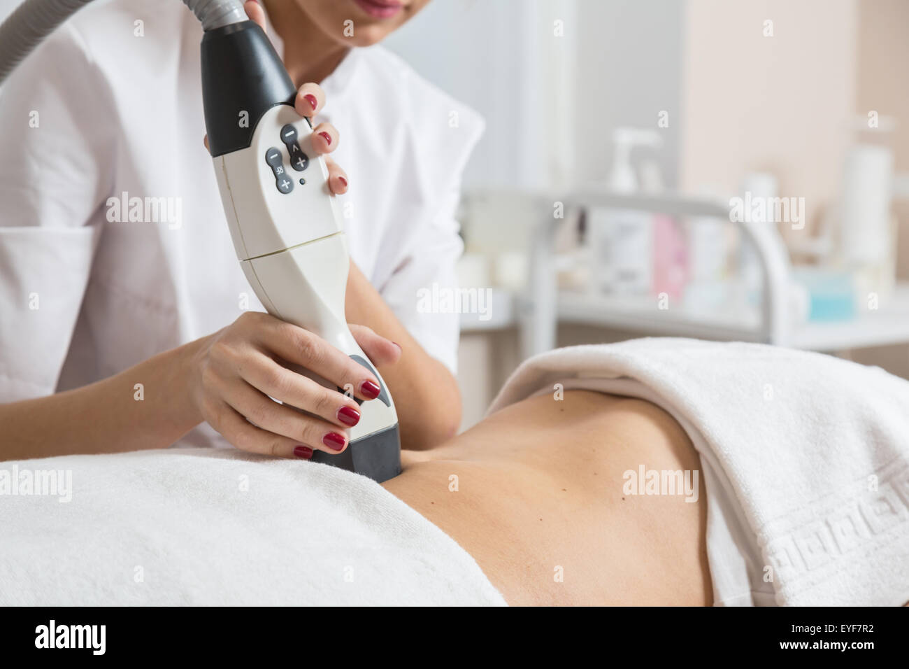 Cosmetician  making procedure of lymphatic drainage with a professional equipment Stock Photo