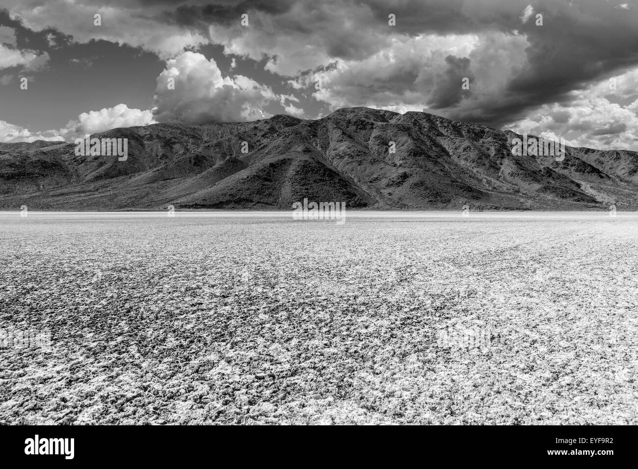 Mojave desert dry lake salt flat with dark storm clouds. Stock Photo
