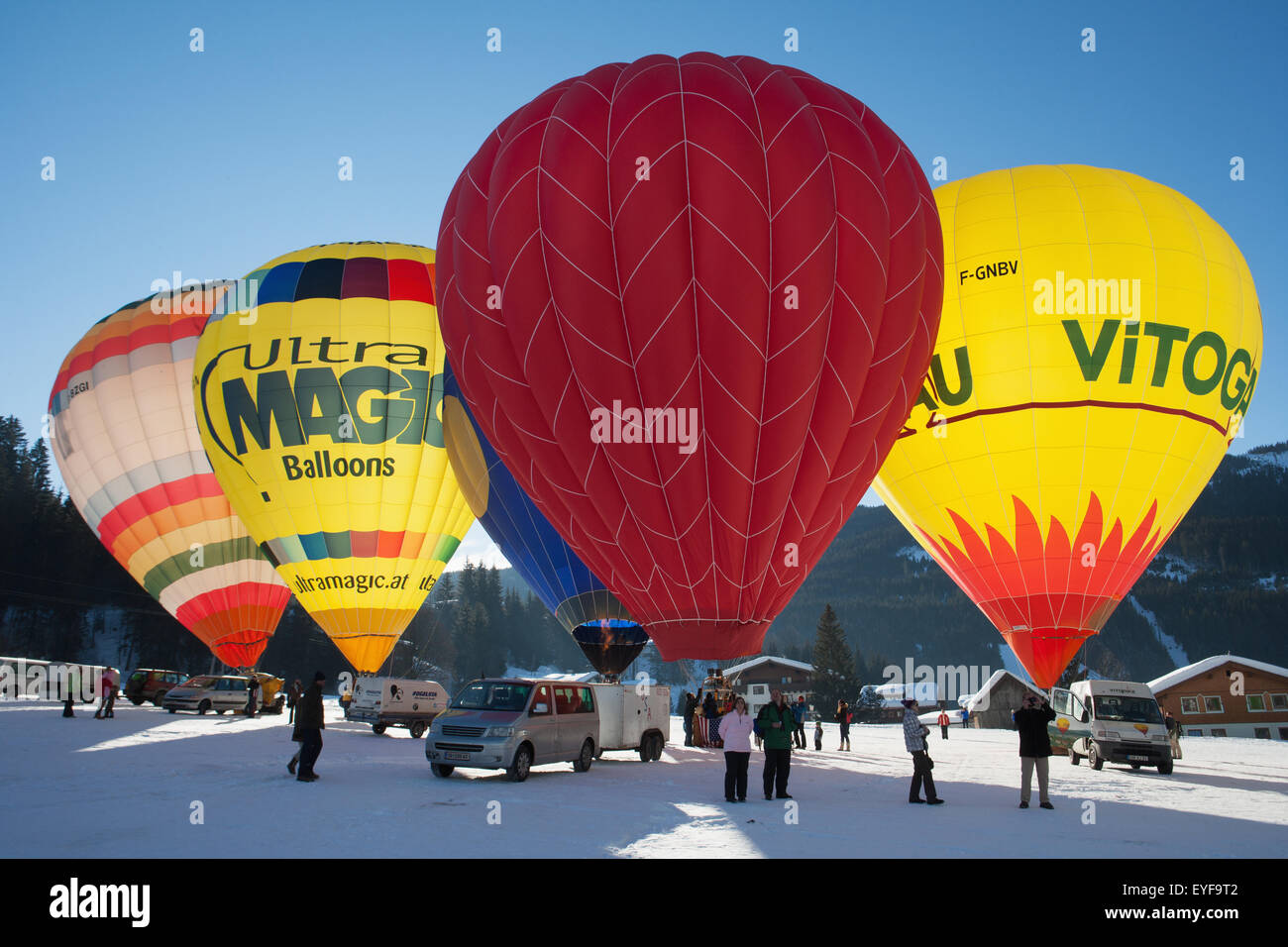 Tourists watch as hot air balloons ready for lift-off during the ski resort's annual hot air balloon festival; Filzmoos, Austria Stock Photo