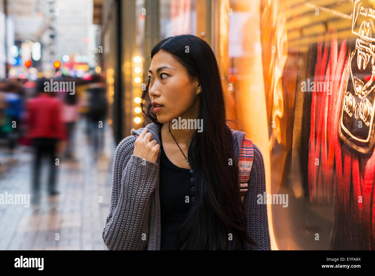 A young woman shopping along the street, Kowloon; Hong Kong, China Stock Photo