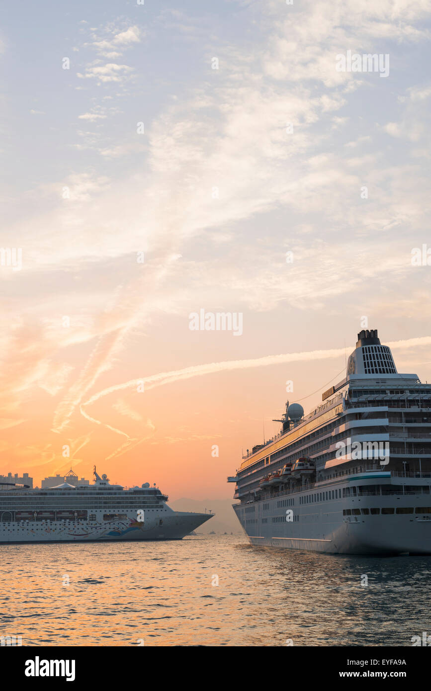 Cruise ships in the harbour at sunset, Kowloon; Hong Kong, China Stock Photo