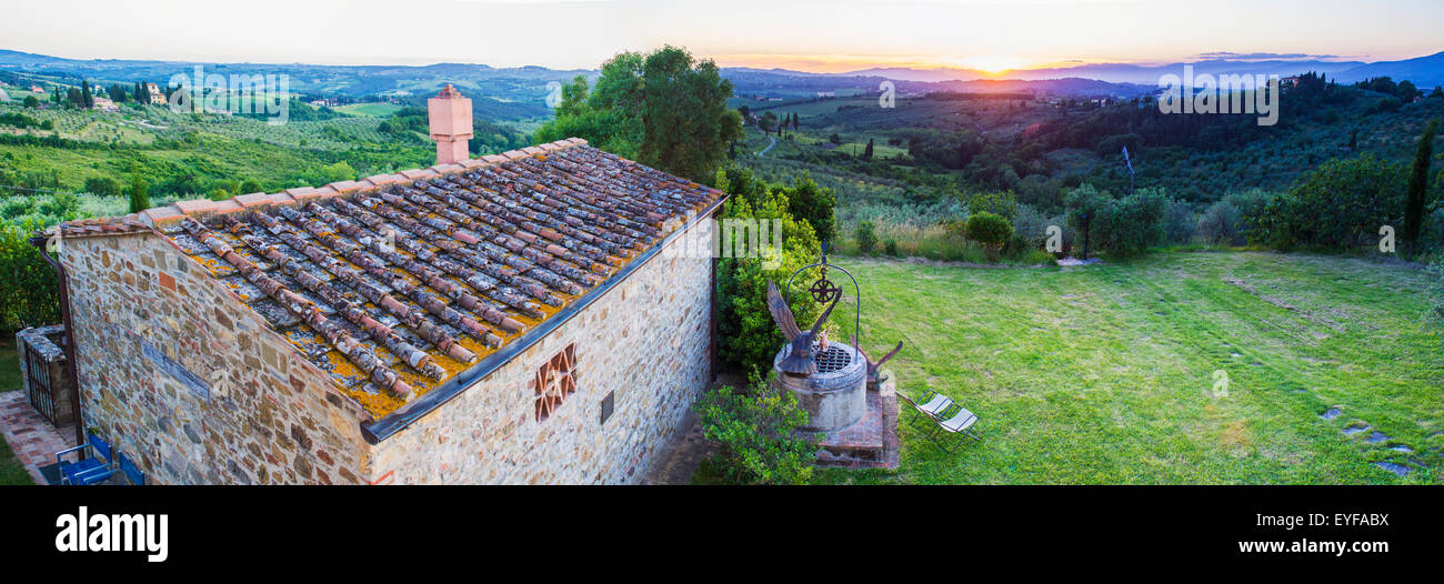 A stone house and a view of the lush landscape at sunset, Villa Capanuccia; Florence, Italy Stock Photo