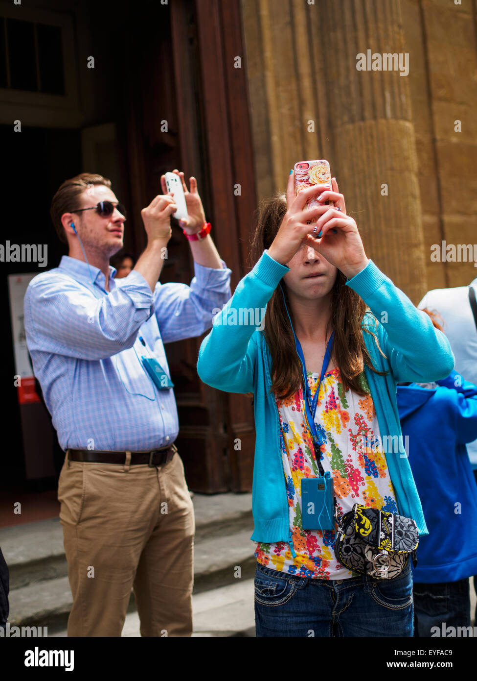 Tourists on the streets of Florence capture photos with their smart phones; Florence, Italy Stock Photo