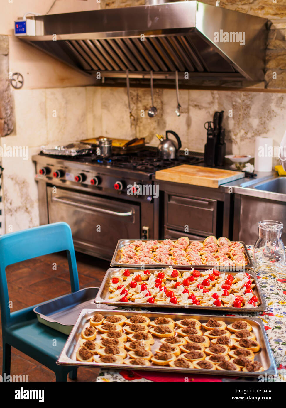 Hors d'oeuvres prepped for the oven in the kitchen of a large villa; Tuscany, Italy Stock Photo
