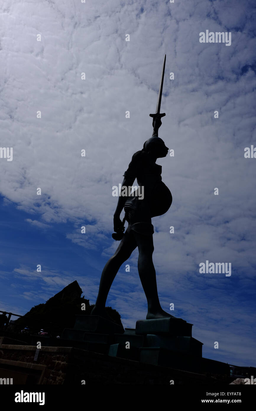 The bronze statue "Verity" by Damien Hirst in silhouette against the